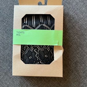 Black crocheted tights. Fishnet like with floral motif.